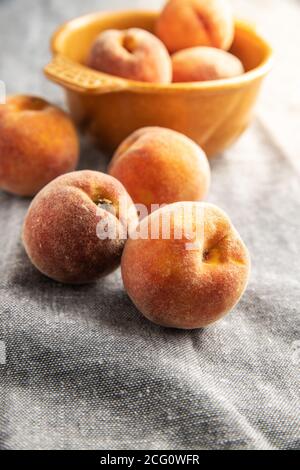 Fresh ripe bio peaches on tablecloth. Stock Photo