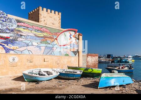 Alexandria, Egypt - December 14, 2018: Fishing boats lay on a coast in old Alexandria fishing harbor Stock Photo