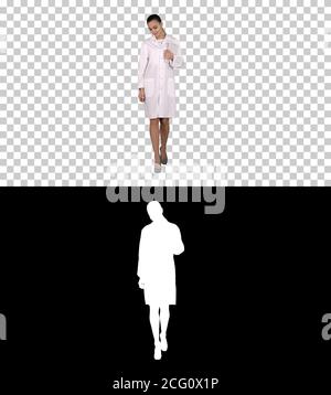 Woman doctor walking with tablet in hands, Alpha Channel Stock Photo