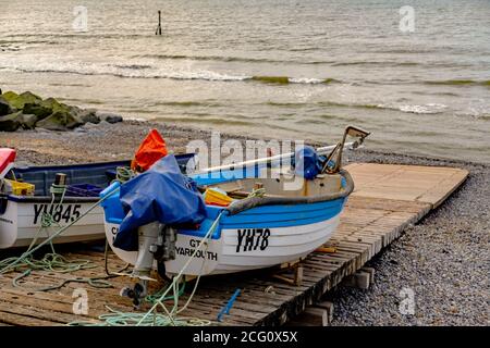 Traditional crab fishing boats on the wooden slip way on Sheringham beach on the North Norfolk coast. Stock Photo