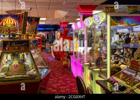 The inside of an amusement arcade with grabber machines, two pence machines and slot machines Stock Photo