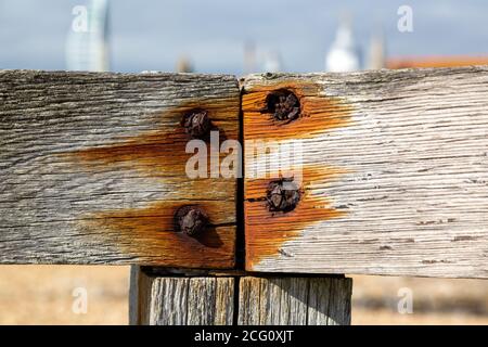 Rusty screws inside wooden planks Stock Photo