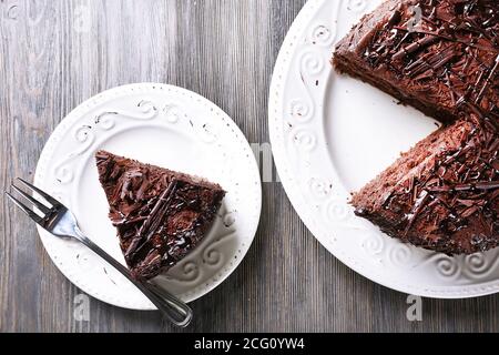 Sliced tasty chocolate cake on wooden table background Stock Photo