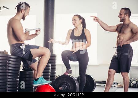 friends relaxing and taking a break after working out at a cross-training gym Stock Photo