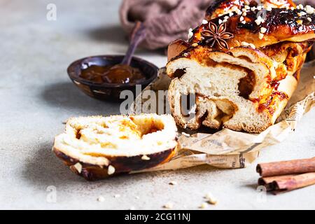 Swirl brioche with apricot jam, nuts, cinnamon and anise star. Braided or roll bread, Babka. Stock Photo