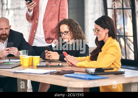 Shot of a group of young business professionals having a meeting. Diverse group of young designers smiling during a meeting at the office.
