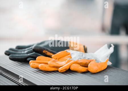 Yellow and Black Protective gloves on anthracite composite deck background Stock Photo