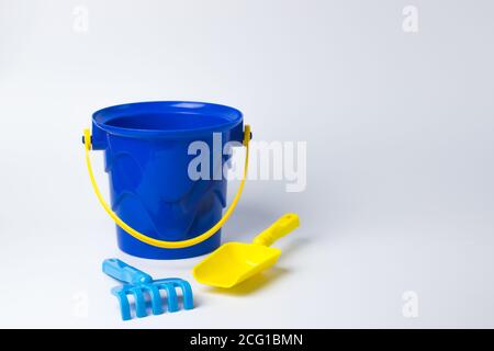 Children's toy. Bucket with a shovel rake on a white background Stock Photo