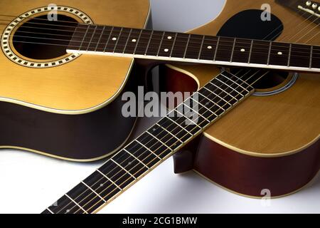 Two guitars lie crosswise on top of each other. Musical instrument. Stock Photo