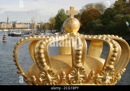 Royal symbol Sweden, gold crown on Skeppsholmbron Stockholm with Strandvagen in background Stock Photo