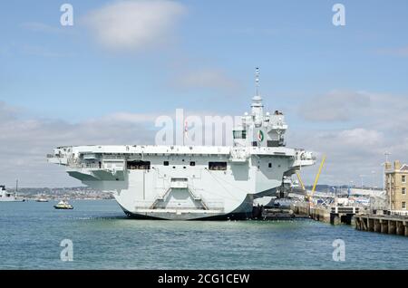 Stern of the massive Queen Elizabeth Aircraft Carrier docked at Portsmouth Harbour, Hampshire.  The Royal Navy ship is the largest in the fleet. Stock Photo