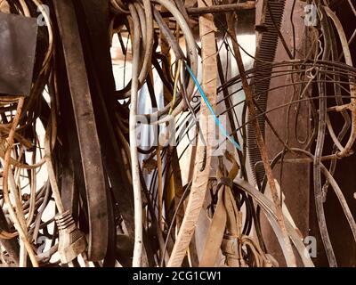 Many old different used electrical cables and wires hanging background Stock Photo