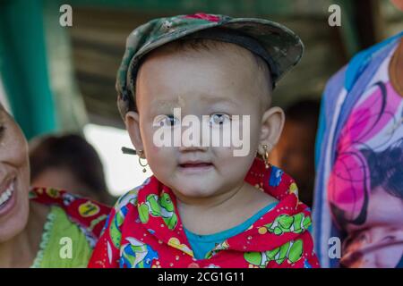 Mawlamyine, Myanmar. November 30, 2016 : A portrait of unidentified young Burmese boy, covered with thanaka paste. High quality photo Stock Photo