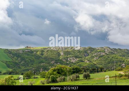 Beautiful Tuscan landscape view with storm clouds in the sky Stock Photo
