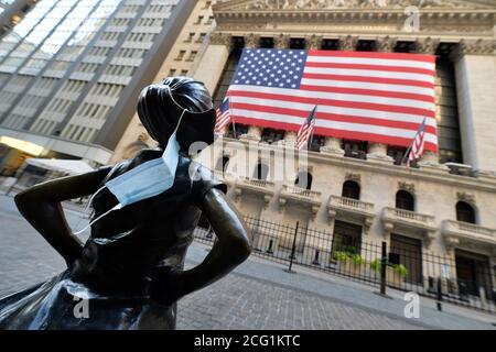 New York City, USA. 08th Sep, 2020. A blue face masks hangs off the ponytail of the “Fearless Girl” bronze statue (by artist Kristen Visbal) which faces the New York Stock Exchange in New York, NY, September 8, 2020. Stocks closed lower as the DOW dropped 630 points due in part to fears of a COVID-19 resurgence and the economic effect it could have on the economy. (Anthony Behar/Sipa USA) Credit: Sipa USA/Alamy Live News Stock Photo