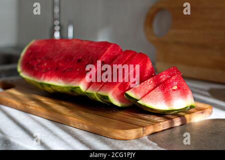 Piece of watermelon sliced on cutting board Stock Photo