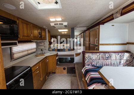 Interior of an Artic Fox truck camper showing the kitchen, dinette and bed. Stock Photo