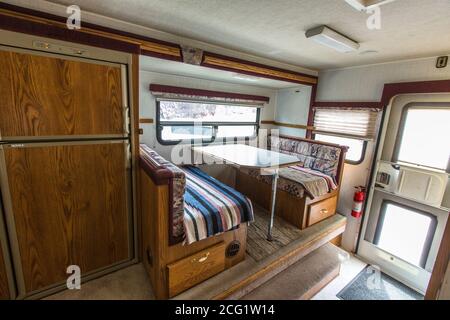 Interior of an Artic Fox truck camper showing the refirgerator and dinette. Stock Photo