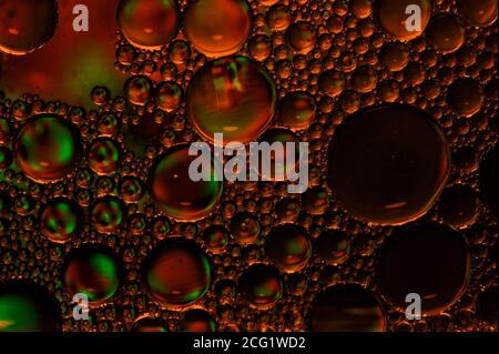 Artistic photo of oil drops close up in red tones for background Stock Photo