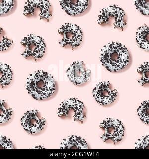 quality seamless pattern of donuts on a pink background top view. Flat lay of delicious nibbled chocolate donuts. Stock Photo