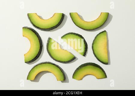 Fresh green avocado slices on white background Stock Photo