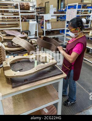 Workers building and assembling guitars at the Taylor Guitar factory in Tecate, Mexico. Stock Photo