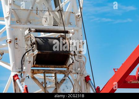 Selective focus on crawler crane with wire rope sling on crane reel. Lifter equipment in construction site. Crawler crane for rent service. Heavy Stock Photo