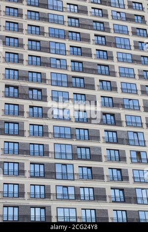 Modern residential building facade with balconies, A view at a straight facade of a modern building. Stock Photo