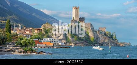 Malcesine - The beach of Lago di Garda lake with the town and castle in the background. Stock Photo
