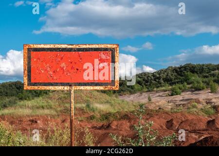Old rusty information abandoned banner in countryside. Located near roadside. Stock Photo