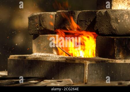 a burning forge made of bricks in nature Stock Photo