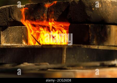 a burning forge made of bricks in nature Stock Photo