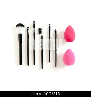 Cosmetic brushes and sponges on white background Stock Photo