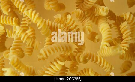 Freeze motion of flying uncooked pasta, food preparation concept Stock Photo