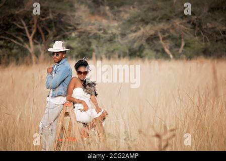 successful lalck couple in african safari with sunglasses posing and ;laughing Stock Photo