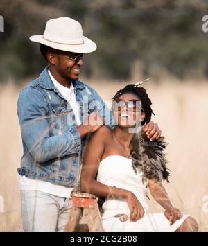 successful lalck couple in african safari with sunglasses posing and ;laughing Stock Photo