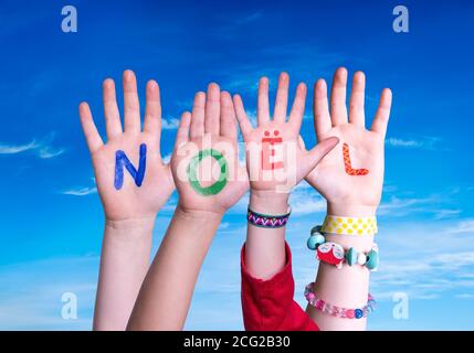 Children Hands Building Word Noel Means Christmas, Blue Sky Stock Photo