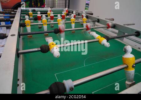 Yellow and red players on a foosball table Stock Photo