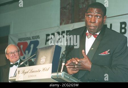 British Heavyweight boxer Frank Bruno speaking at the first ever Annual Dinner of the Professional Boxers Association in London, watched by commentator Harry Carptenter. Bruno received the Round of the Year award for round 3 of his World Heavyweight title challenge against Lennox Lewis. Stock Photo