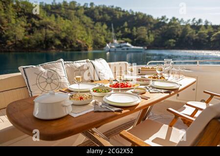 Romantic Dinner on Motor Yacht at Sunset Stock Photo