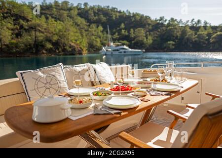 Romantic Dinner on Motor Yacht at Sunset Stock Photo