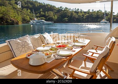 Romantic Dinner on Motor Yacht at Sunset Stock Photo