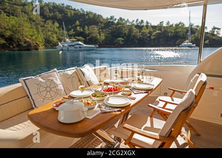 Romantic Dinner on Motor Yacht at Sunset Stock Photo