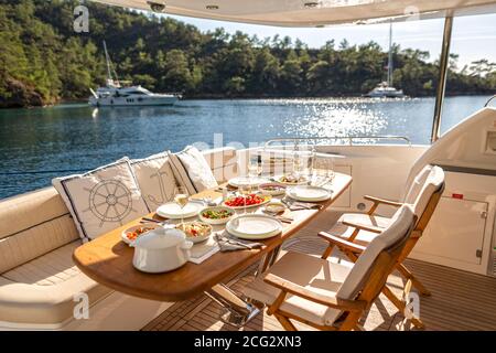 Romantic Dinner on Motor Yacht at Sunset Stock Photo