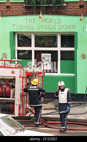 PAP 7. 18/6/85. LONDON. Firemen survey the damage to 'The World Turned Upside Down' public  house in south east London's Old Kent Road today (Sun). One man died and severals others had to be  rescued when the blaze turned the pub into an inferno and police today said they were treating the fire as  'suspicious'. See PA story DEATH Fire. Photo by Gill Allan/PA. Stock Photo