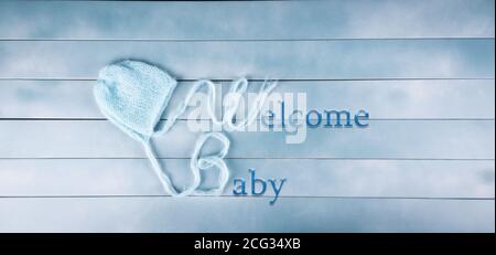 Welcome baby boy on wood background. Baby shower, birthday, invitation or greeting card idea. Newborn concept. Copy space. Stock Photo