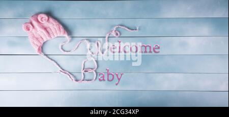 Welcome baby girl on wood background. Baby shower, birthday, invitation or greeting card idea. Newborn concept. Copy space. Stock Photo