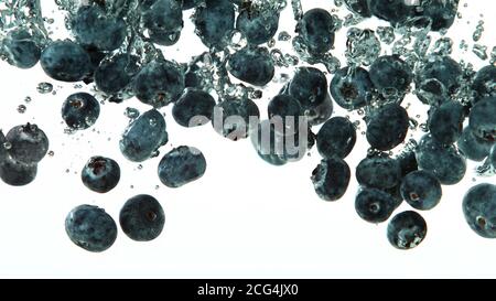 Blueberries falling into water isolated on white background Stock Photo