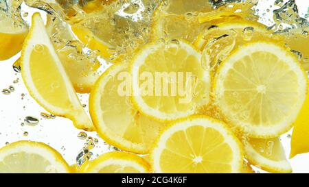Lemon Slices falling deeply under water isolated on white background Stock Photo