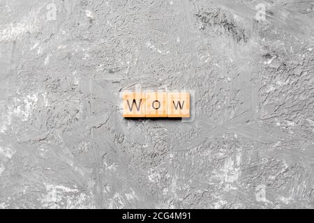 WOW word written on wood block. WOW text on cement table for your desing, concept. Stock Photo
